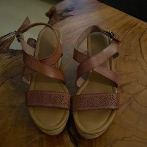 Cork platforms with brown leather strap.